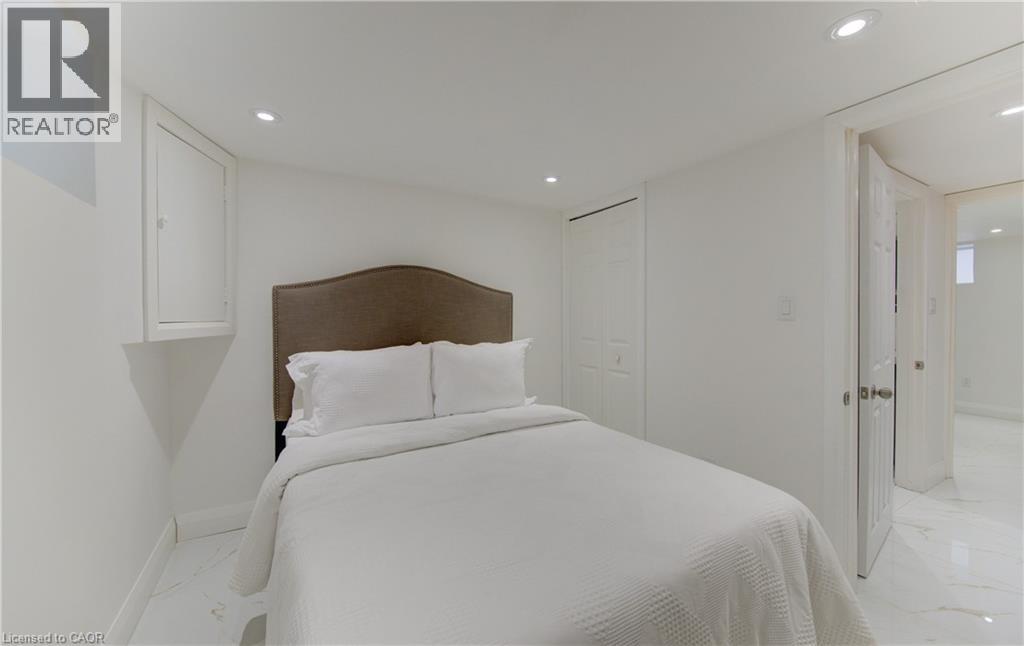 A bedroom with a large bed and a white bedspread.