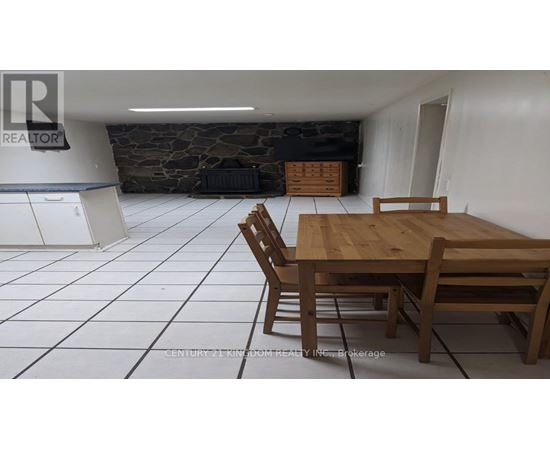 A dining room with a wooden table and chairs.
