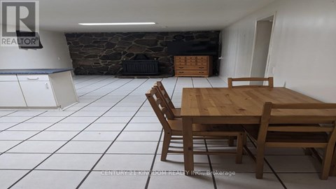 A dining room with a wooden table and chairs.