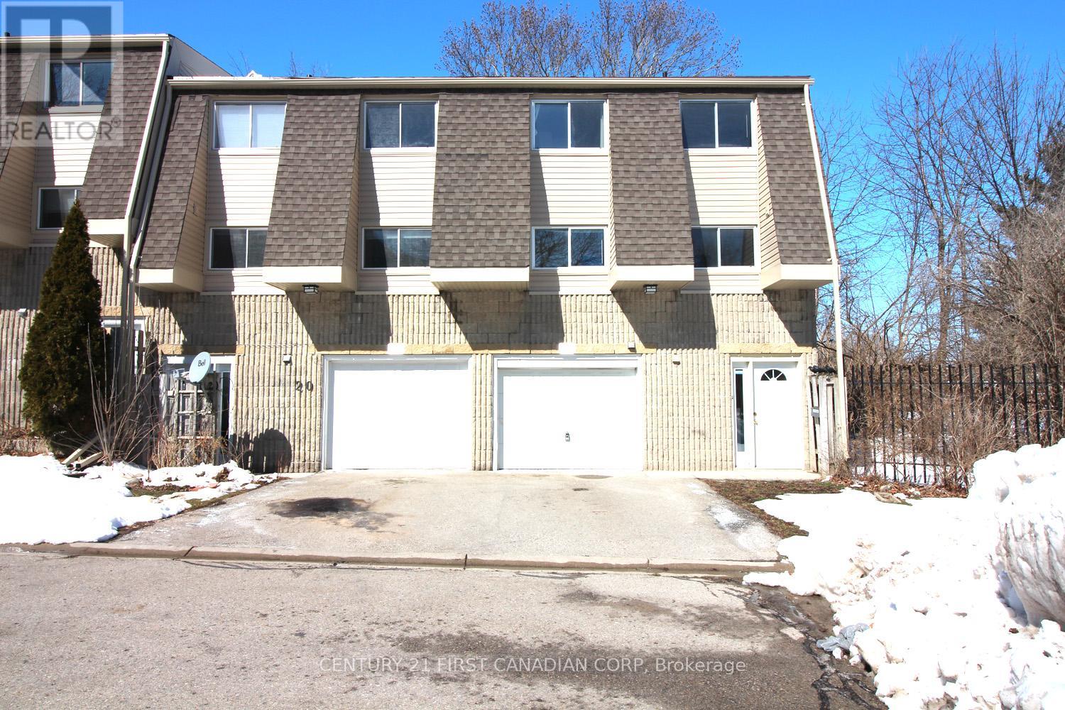 A large building with a garage door is for sale.