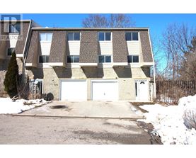 A large building with a garage door is for sale.