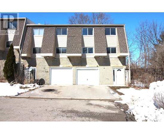 A large building with a garage door is for sale.