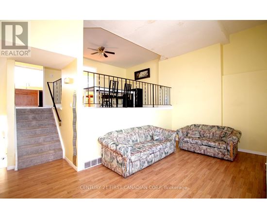 A living room with a couch and a cushioned chair.