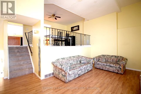 A living room with a couch and a cushioned chair.