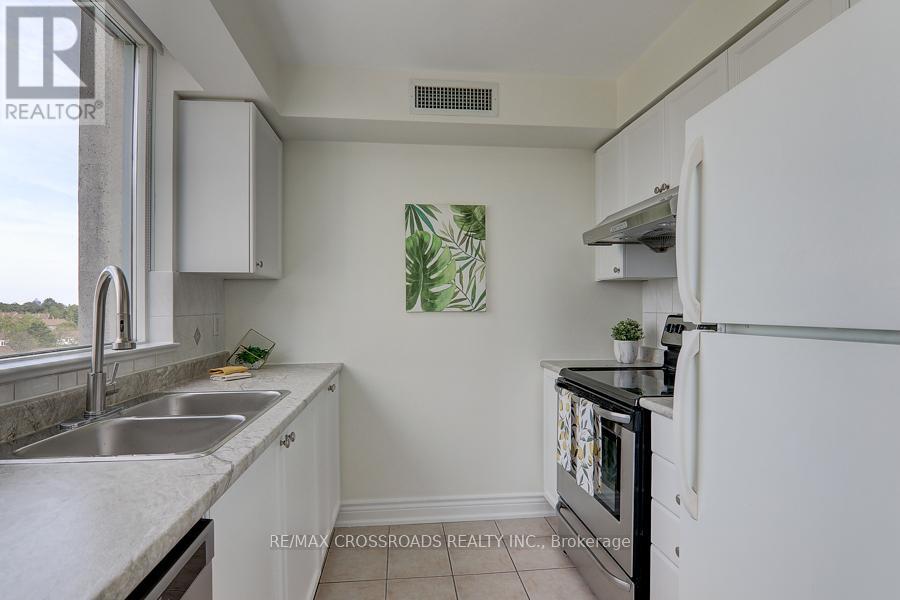 A kitchen with white cabinets and a black stove top oven.