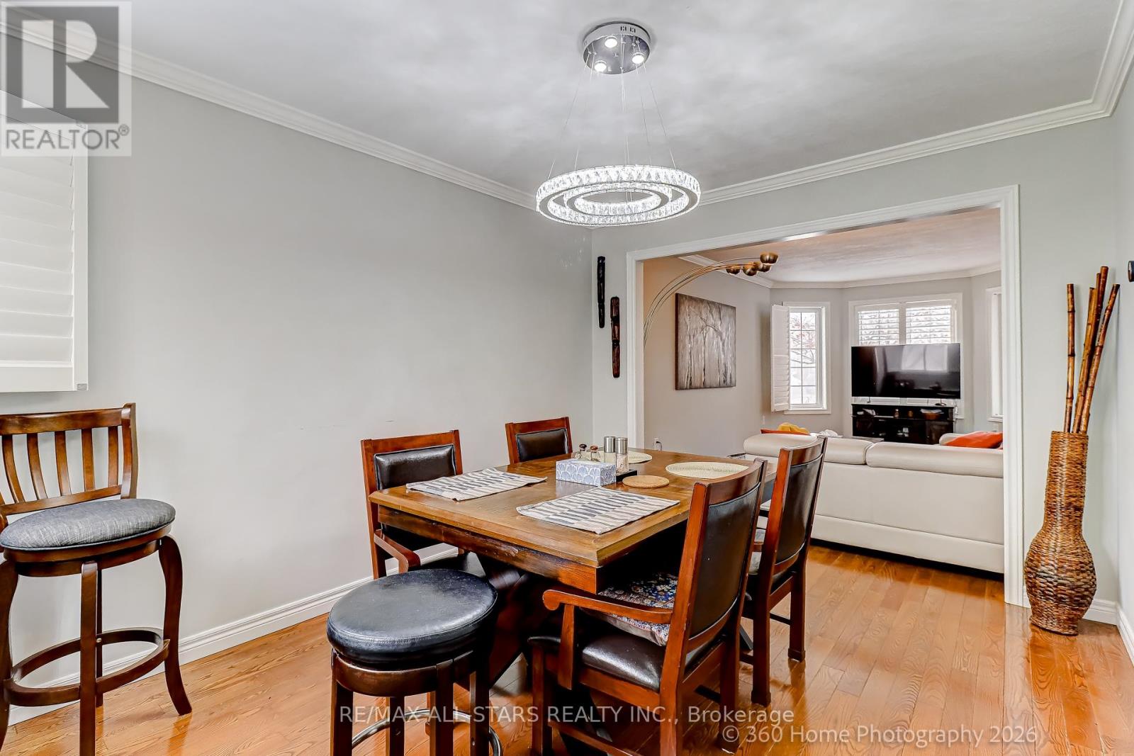 A dining room with a wooden table and chairs.