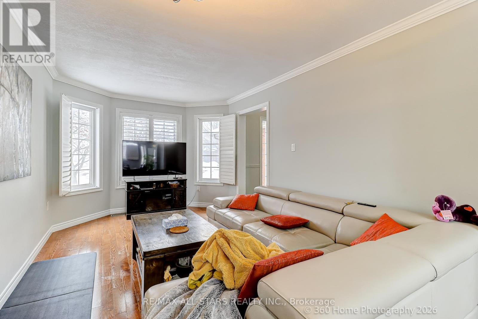 A living room with a white couch and a coffee table.