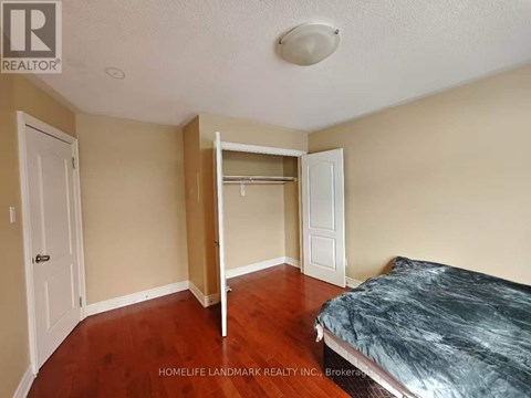 A bedroom with a bed, dresser, and mirror.