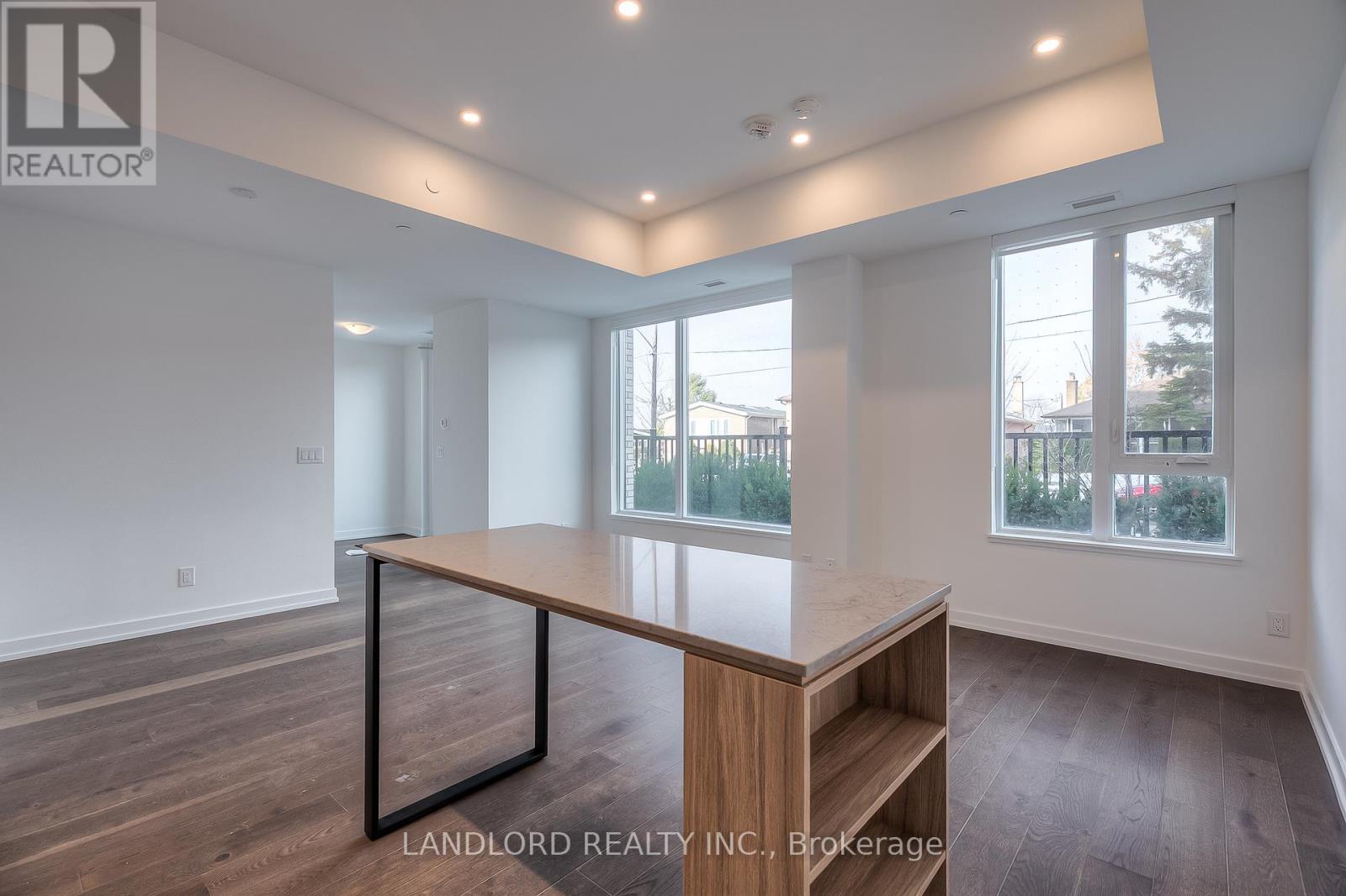 A spacious room with a wooden table and bench seating.