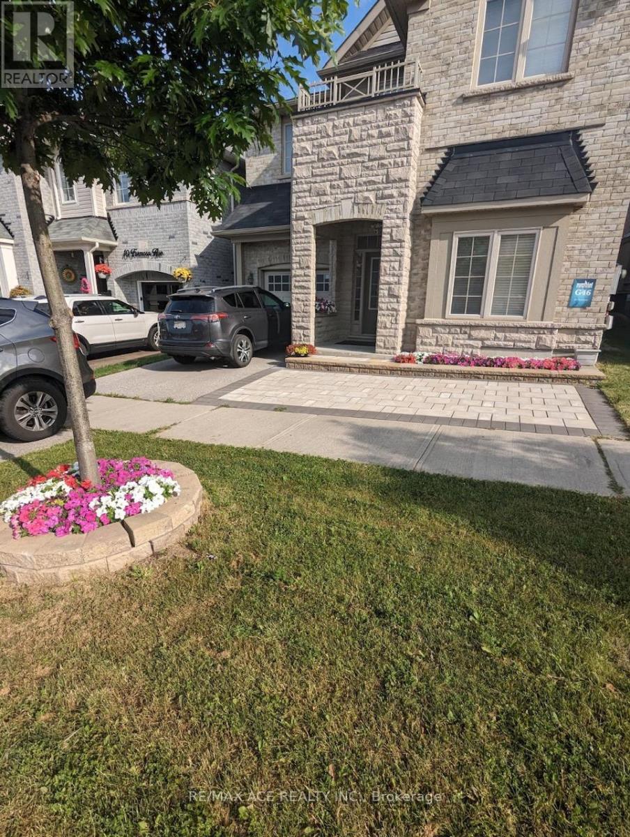 A stone house with a flower bed in front.