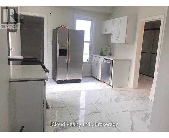 A kitchen with a refrigerator, stove, and sink.