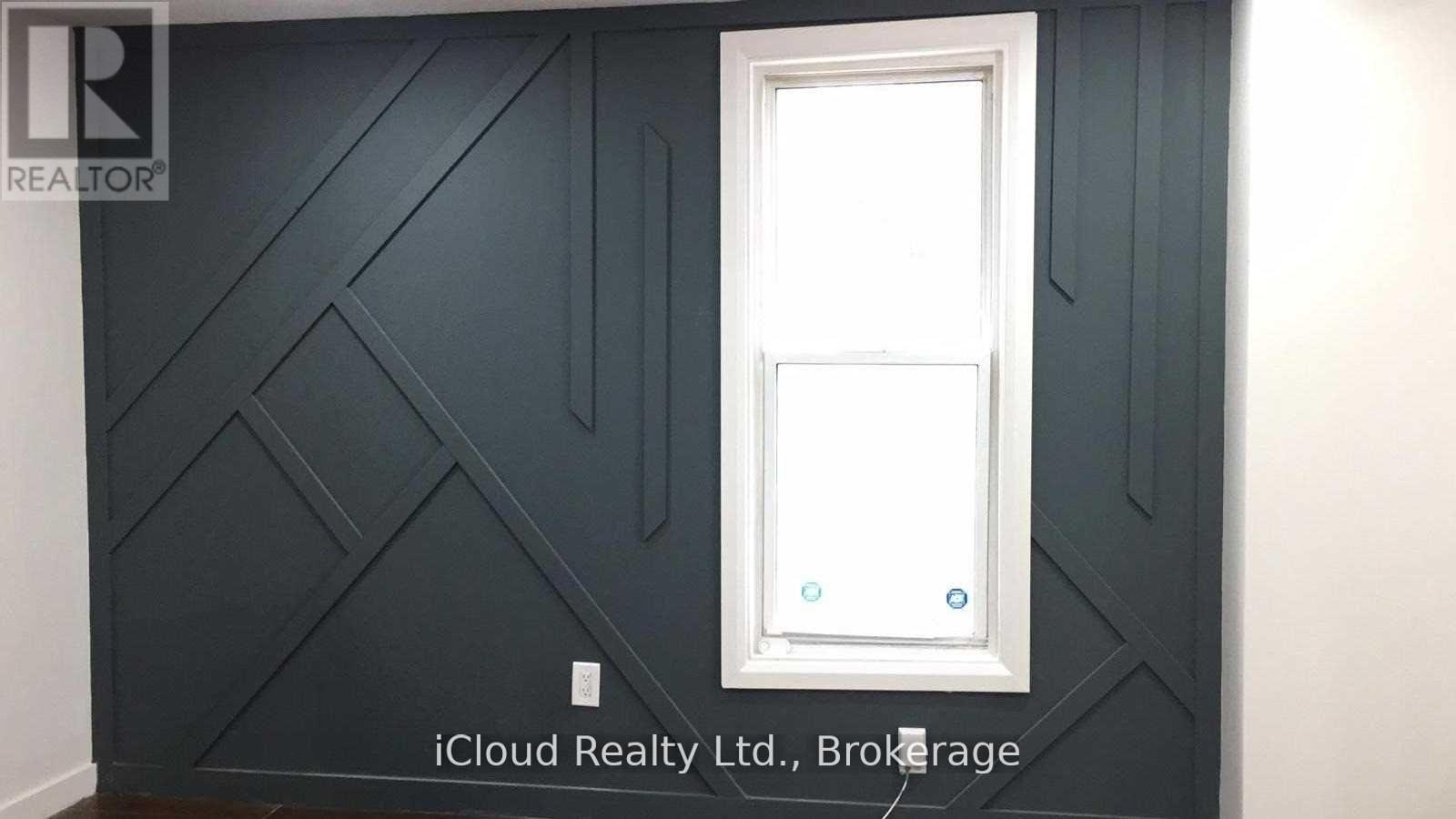 A white door is in a room with dark grey walls.