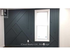 A white door is in a room with dark grey walls.