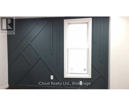 A white door is in a room with dark grey walls.
