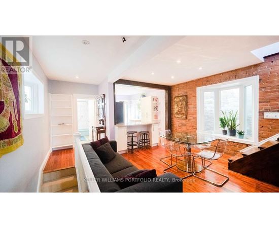 A living room with a glass table and a couch.