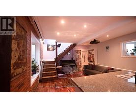 A living room with a staircase leading to the upper floor.