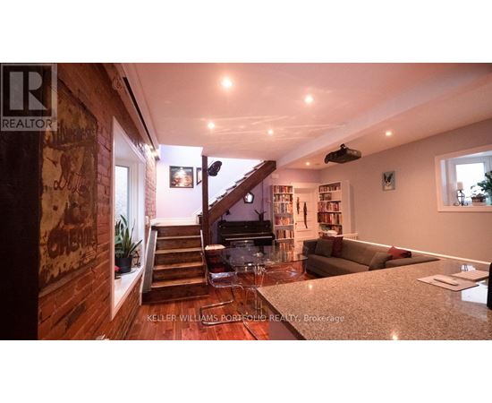 A living room with a staircase leading to the upper floor.