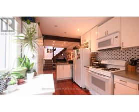 A kitchen with white cabinets and a stove top oven.
