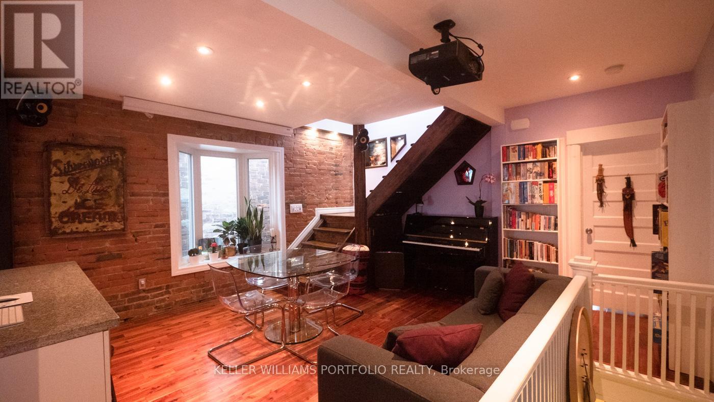 A living room with a piano and a television.
