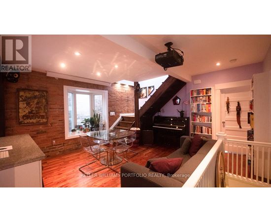 A living room with a piano and a television.