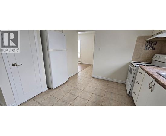 A kitchen with white appliances and cabinets.