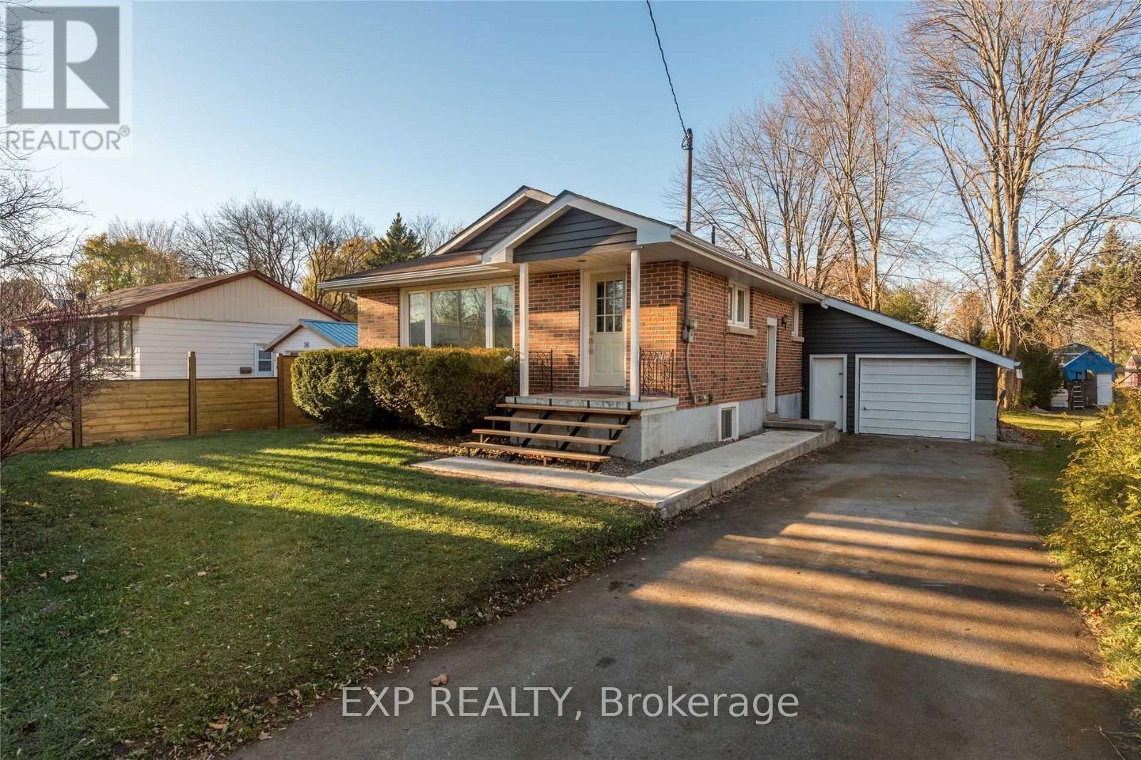 A house with a driveway in front of it is for sale.
