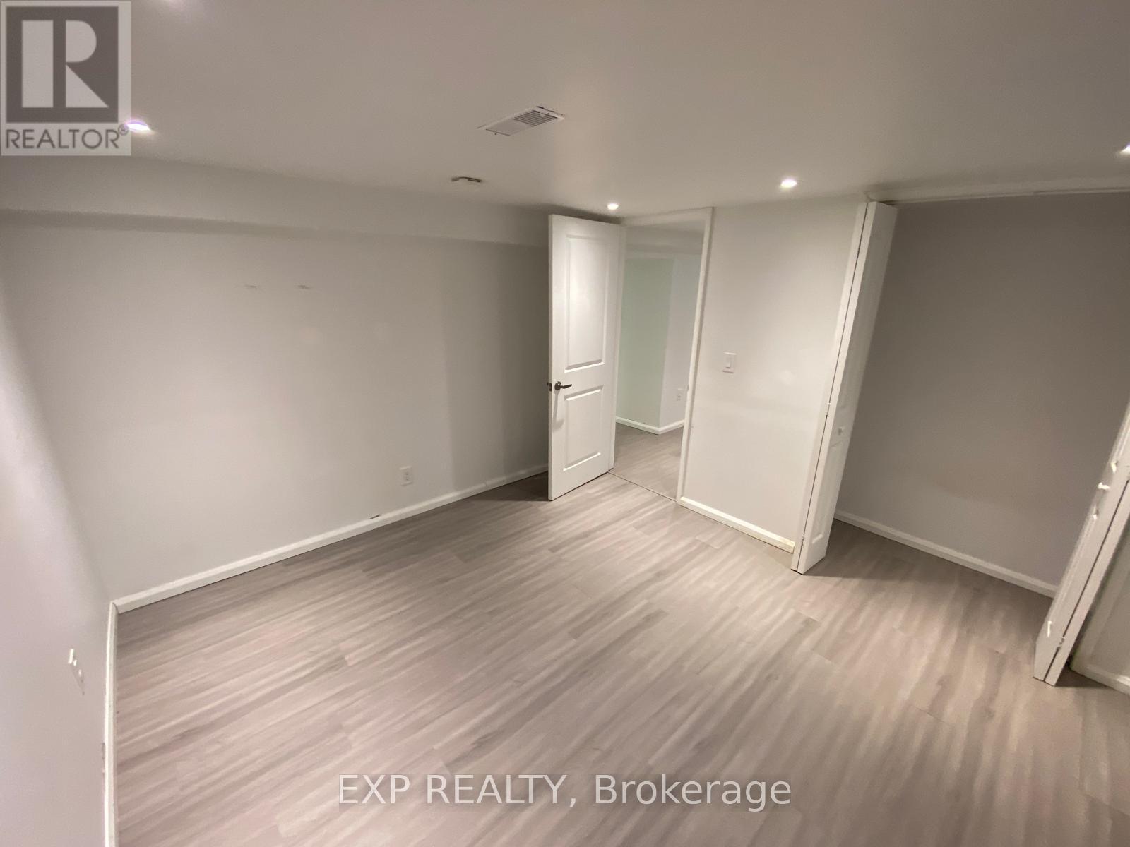 A room with EXP REALTY, Brokerage written on the floor.