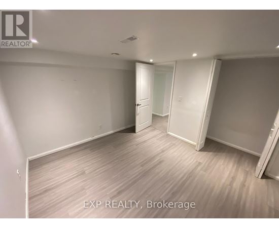 A room with EXP REALTY, Brokerage written on the floor.