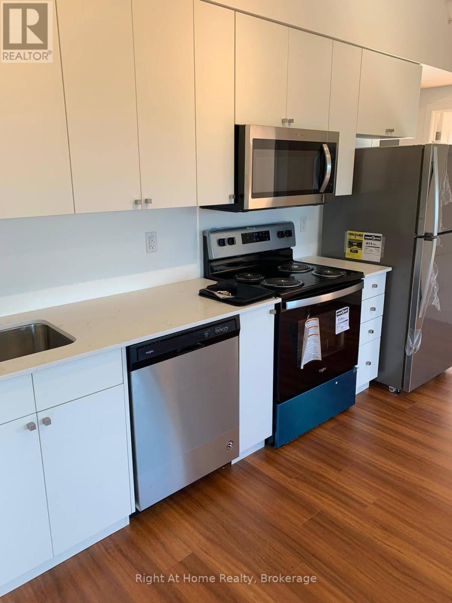 A kitchen with white cabinets and a stainless steel dishwasher.