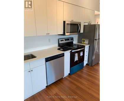 A kitchen with white cabinets and a stainless steel dishwasher.