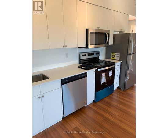 A kitchen with white cabinets and a stainless steel dishwasher.