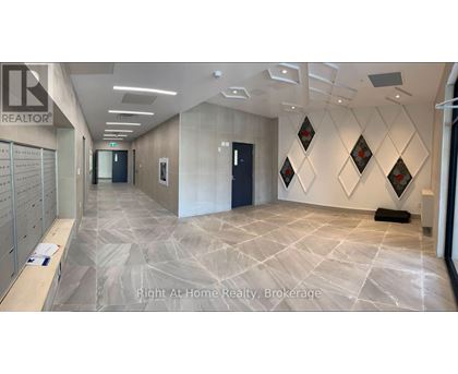 A hallway with a tiled floor and a wall with diamond-shaped decorations.