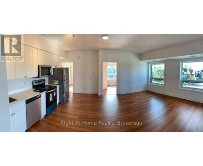 A large open living space with wood floors and white walls.