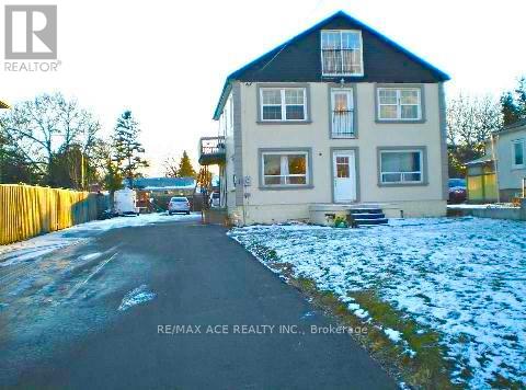 A house with a snowy front yard is for sale.