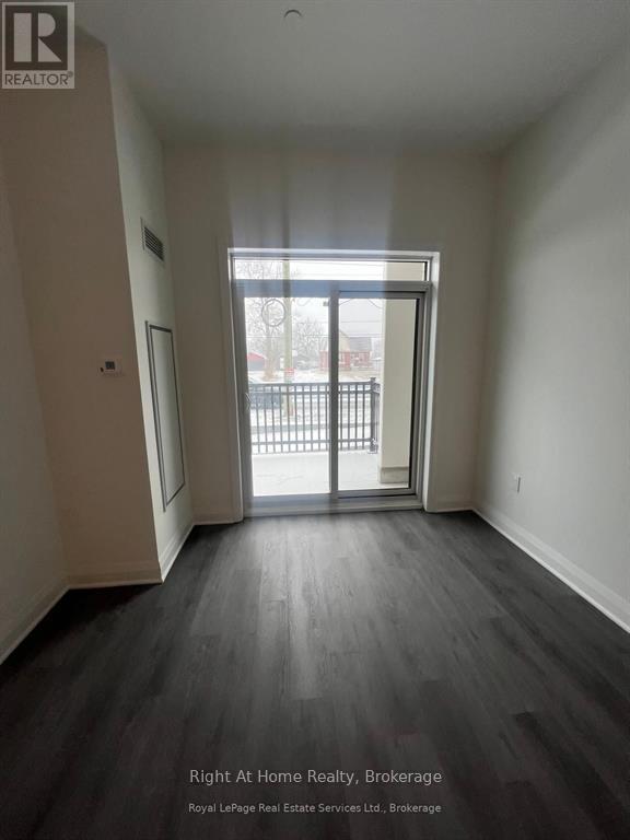 A room with a sliding glass door leading to a balcony.