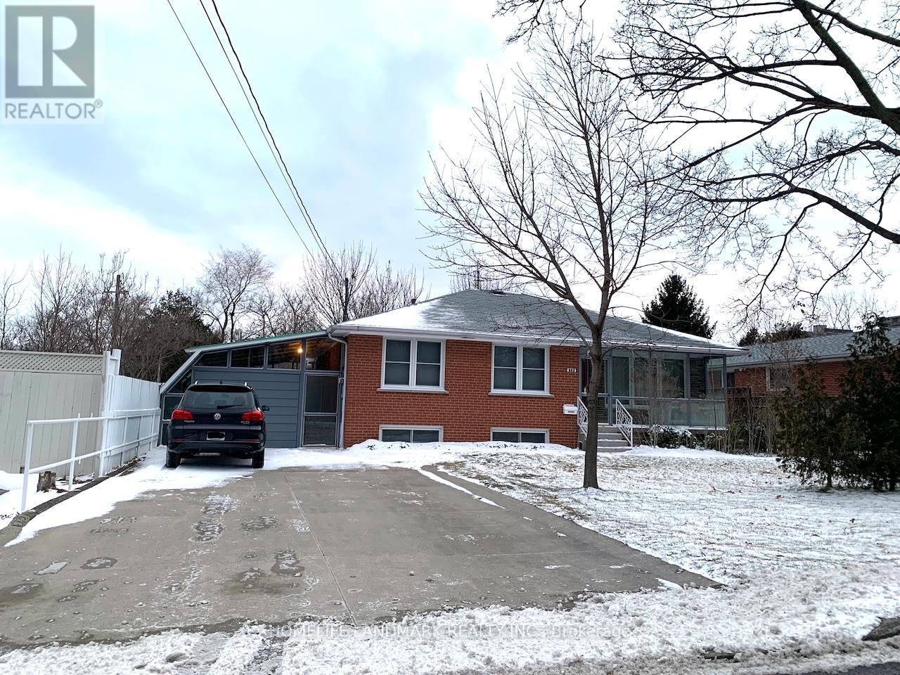 A house with a car parked in front of it.