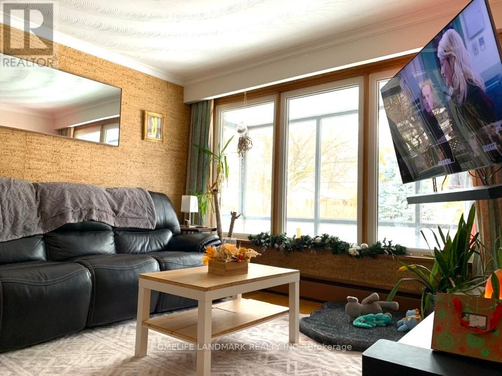 A living room with a black leather sofa and a wooden coffee table.