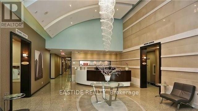 A reception area with a table and chairs and a sign that says "EASTIDE REALTOR Brokerage".