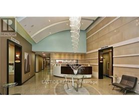 A reception area with a table and chairs and a sign that says "EASTIDE REALTOR Brokerage".