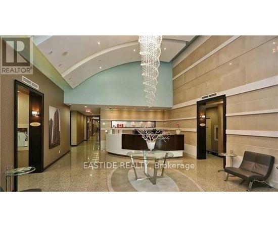 A reception area with a table and chairs and a sign that says "EASTIDE REALTOR Brokerage".