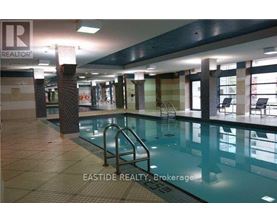 A pool inside a building with a REALTOR sign.