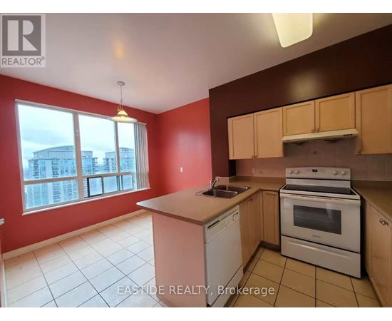 A kitchen with red walls and white appliances.