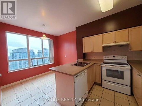A kitchen with red walls and white appliances.