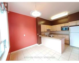 A kitchen with red walls and white appliances.