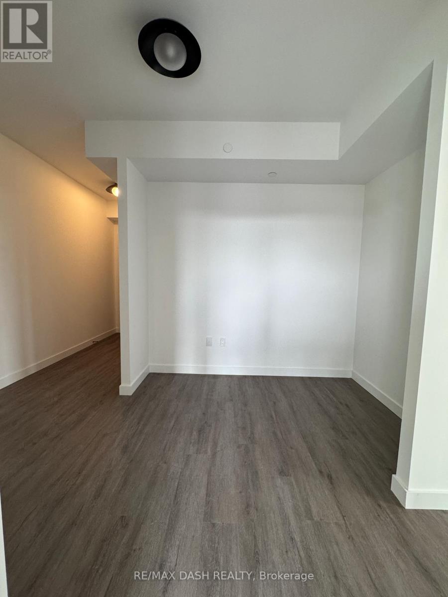 A room with a wooden floor and white walls.
