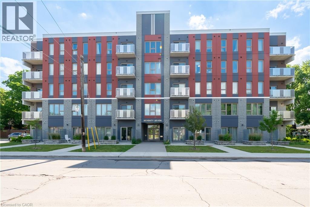 A large apartment building with a red and grey facade.