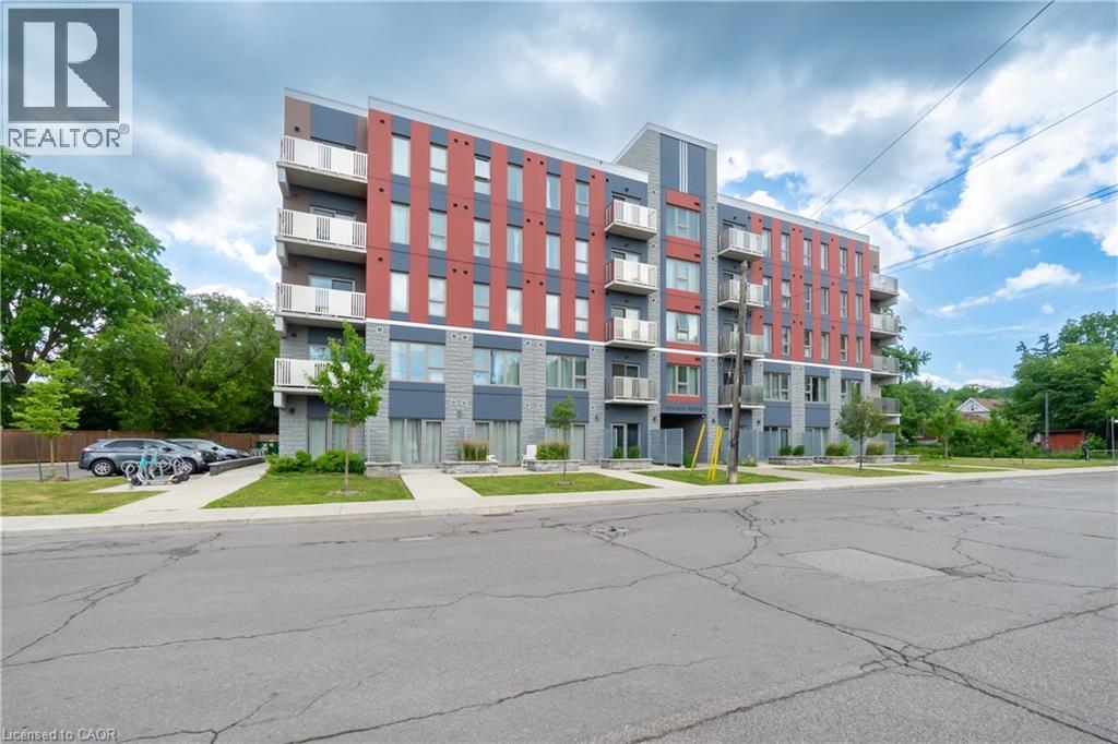 A multi-story apartment building with a parking lot in front.