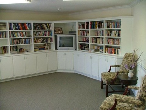 A living room with a television and a bookshelf.