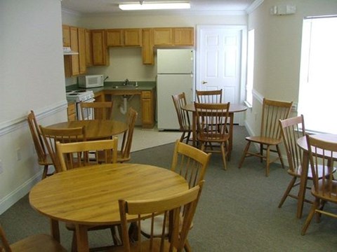 A kitchen with a table and chairs.