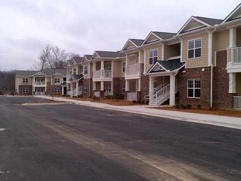 A row of townhouses with a street in front.